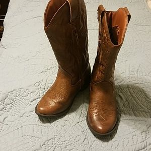 Gently worn brown cowboy boots.